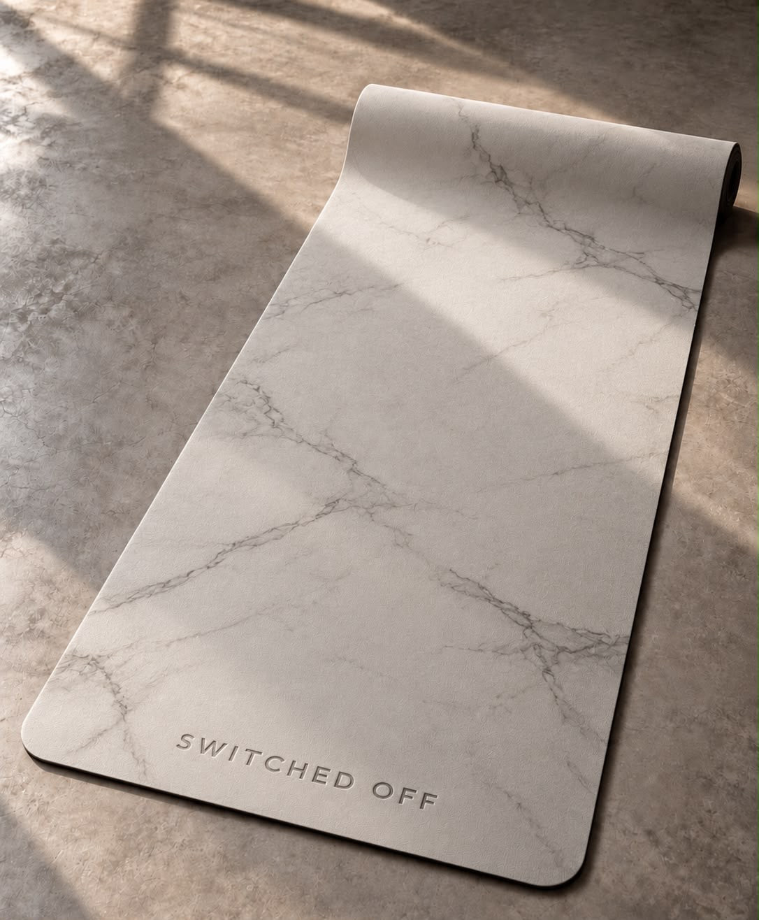 Cream marble yoga mat with an embossed SWITCHED OFF logo